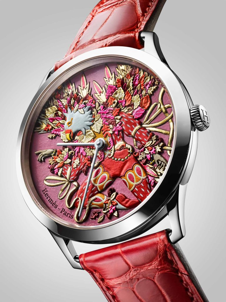 Red Hermès watch with an autumn motif, featuring an eagle character surrounded by autumn leaves.