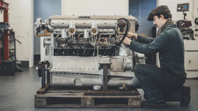 An engineer works on a car engine made up of over 600 bespoke parts.